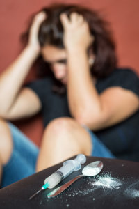 A woman struggles with drug withdrawal symptoms