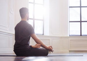 man participating in yoga therapy