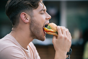 man eating food needing binge eating disorder treatment